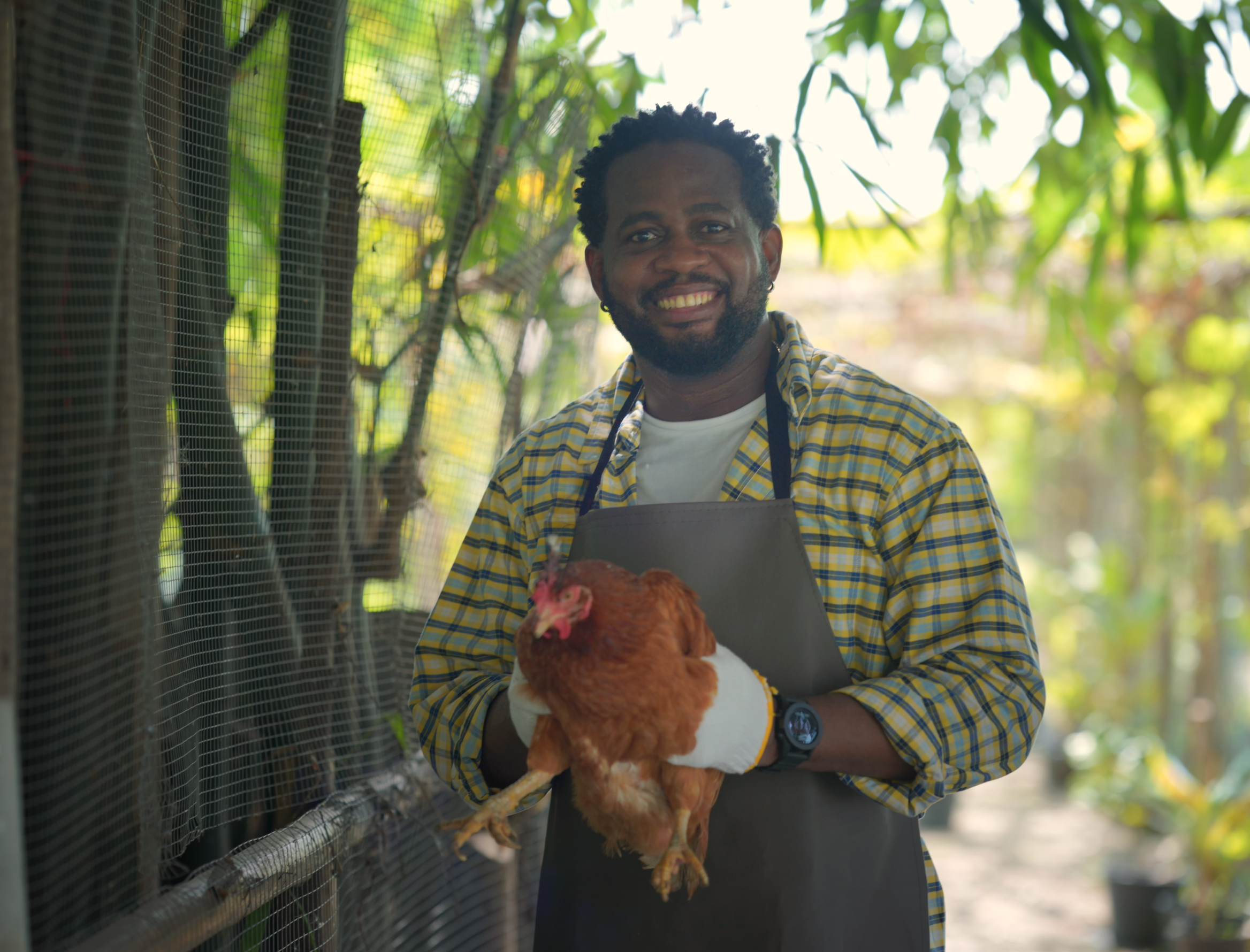 A man holding a hen